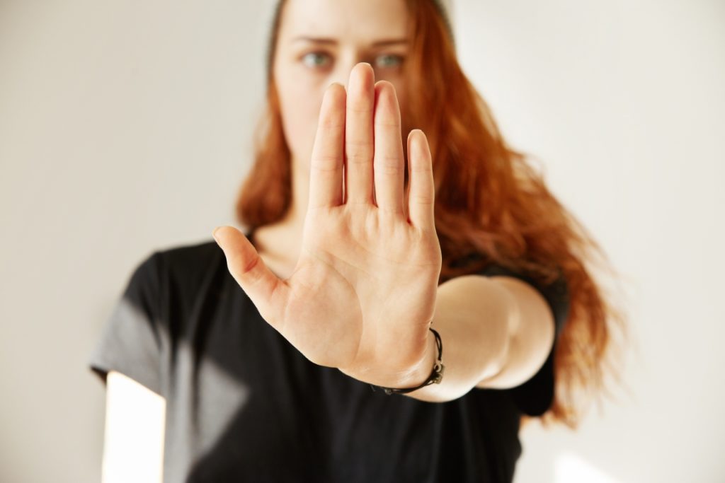 close up view young woman making stop gesture with her hand
